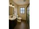Stylish bathroom features a sleek vanity, dark wood floors, and modern fixtures, creating a luxurious feel at 8325 Sun Vista Way, Orlando, FL 32822