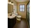Modern bathroom with a sleek vanity, a framed mirror, and a glass-enclosed shower at 8325 Sun Vista Way, Orlando, FL 32822