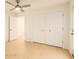 Comfortable bedroom with a ceiling fan, a closet, and a door, offering a relaxing and private space at 8325 Sun Vista Way, Orlando, FL 32822