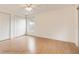Spacious bedroom with light wood floors, double closets, and a large window offering ample natural light at 8325 Sun Vista Way, Orlando, FL 32822