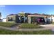 Well-manicured lawn with a single-story home, car parked in the driveway, and attached garage at 8325 Sun Vista Way, Orlando, FL 32822