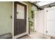 Inviting front entrance with a black door, light green exterior, and charming garden accents for added curb appeal at 8325 Sun Vista Way, Orlando, FL 32822