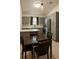 Well-lit kitchen features gray cabinets, stainless steel appliances, and a cozy dining area, perfect for Gathering meals at 8325 Sun Vista Way, Orlando, FL 32822