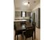 A well-lit kitchen and dining area with grey cabinets and stainless-steel appliances at 8325 Sun Vista Way, Orlando, FL 32822