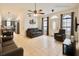 Bright living room with tile flooring, ceiling fan, and adjacent view of the kitchen at 8325 Sun Vista Way, Orlando, FL 32822