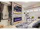 Comfortable living room with an electric fireplace, mounted television, and a gray rug at 8325 Sun Vista Way, Orlando, FL 32822