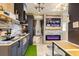 Modern living space features a fireplace, television, and kitchen with light-wood countertops at 8325 Sun Vista Way, Orlando, FL 32822