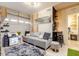 Cozy living space with a gray sectional sofa, mirror, and a laundry basket at 8325 Sun Vista Way, Orlando, FL 32822