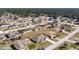 Expansive aerial view of a neighborhood with well-maintained homes and lush greenery at 8509 Sw 136Th Loop, Ocala, FL 34473
