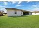 View of the backyard with a large, well-maintained lawn at 8509 Sw 136Th Loop, Ocala, FL 34473