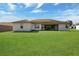 View of the backyard with a large, well-maintained lawn at 8509 Sw 136Th Loop, Ocala, FL 34473