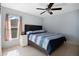 Bedroom featuring natural light, tile floors, a ceiling fan and queen size bed at 8509 Sw 136Th Loop, Ocala, FL 34473