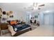 Spacious bedroom with light blue walls, ceiling fan, and tile flooring at 8509 Sw 136Th Loop, Ocala, FL 34473