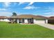 Charming single-story home featuring a well-maintained lawn and attached two-car garage at 8509 Sw 136Th Loop, Ocala, FL 34473