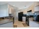 Kitchen with light cabinets, appliances, tile flooring and lots of counter space at 8509 Sw 136Th Loop, Ocala, FL 34473