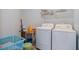 Laundry room with washer, dryer, shelving, and storage at 8509 Sw 136Th Loop, Ocala, FL 34473