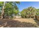 Large fenced backyard with mature trees offering ample shade at 3673 Westland Ct, Orlando, FL 32818