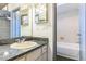 This bathroom has a vanity and sink, plus a view of the bathtub and shower at 3673 Westland Ct, Orlando, FL 32818