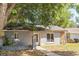 Charming single story home featuring stone accents, mature landscaping, and a cozy front porch at 3673 Westland Ct, Orlando, FL 32818