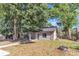 Front of the home with large trees in the front yard at 3673 Westland Ct, Orlando, FL 32818