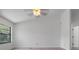 Neutral bedroom with tile floor, ceiling fan, and a large window for natural light at 10030 Cheshunt Dr, Orlando, FL 32817