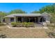 Exterior view of the home with a screened-in patio and landscaping at 10030 Cheshunt Dr, Orlando, FL 32817