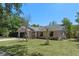 Inviting single-story home with a manicured lawn, stone accents, and a convenient two-car garage at 10030 Cheshunt Dr, Orlando, FL 32817