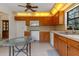 Traditional kitchen features wooden cabinets, tile backsplash, and tiled floors at 10030 Cheshunt Dr, Orlando, FL 32817