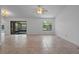 Spacious living room with tile flooring, ceiling fan, and sliding glass doors to the patio at 10030 Cheshunt Dr, Orlando, FL 32817