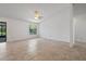 Bright, spacious living room with tile floors, a ceiling fan, and a large window at 10030 Cheshunt Dr, Orlando, FL 32817