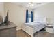 Well-lit bedroom with ceiling fan, a window, and a comfortable bed at 1052 Cascade Dr, Davenport, FL 33837