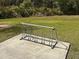Outdoor bike rack on a cement slab surrounded by grass, providing convenient storage for bicycles at 1052 Cascade Dr, Davenport, FL 33837