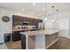 Spacious kitchen features dark wood cabinets and a large island with a granite countertop at 1052 Cascade Dr, Davenport, FL 33837