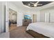 Beautiful main bedroom boasts a tray ceiling, ceiling fan and a dresser with television at 1052 Cascade Dr, Davenport, FL 33837