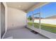 Enclosed patio with view of the landscaped backyard at 1052 Cascade Dr, Davenport, FL 33837