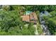 Stunning aerial view of the home featuring a tile roof, lush landscaping, a sparkling pool, and a large yard at 1110 Greenwood St, Orlando, FL 32801