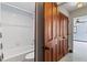 Bright bathroom with white tile shower, tub, and vanity with storage; and hardwood floors at 1110 Greenwood St, Orlando, FL 32801