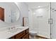 Updated bathroom with glass shower, round mirror, and tiled floors at 1110 Greenwood St, Orlando, FL 32801