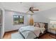Bright bedroom with hardwood floors, area rug, ceiling fan, and large window at 1110 Greenwood St, Orlando, FL 32801