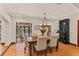 Well-lit dining room with rustic table, six chairs, and a view to outdoor pool at 1110 Greenwood St, Orlando, FL 32801