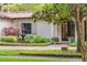Close up of front facade with lush landscaping, tiled roof, fountain and brick walkway at 1110 Greenwood St, Orlando, FL 32801