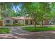 Charming home featuring a well-manicured front yard, tile roof, fountain, and arched entryway at 1110 Greenwood St, Orlando, FL 32801