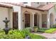 Inviting front porch with arched entryways, water fountain, and manicured garden at 1110 Greenwood St, Orlando, FL 32801