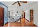 Spacious upstairs hallway with hardwood floors, black iron railing, and natural lighting at 1110 Greenwood St, Orlando, FL 32801