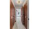 Hallway featuring a row of wood closets and a view into another room at 1110 Greenwood St, Orlando, FL 32801