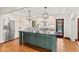 Modern kitchen with an island, stainless steel appliances, and designer pendant lights at 1110 Greenwood St, Orlando, FL 32801