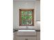 Modern farmhouse kitchen sink with wood framed window and white subway tile backsplash at 1110 Greenwood St, Orlando, FL 32801