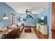 Comfortable living room featuring blue walls, leather couch, and television at 1110 Greenwood St, Orlando, FL 32801