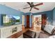 Comfortable living room featuring hardwood floors, a ceiling fan, a flatscreen TV, and elegant wooden trim at 1110 Greenwood St, Orlando, FL 32801