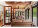 Cozy sunroom with wood ceilings, tile flooring, and multiple french doors at 1110 Greenwood St, Orlando, FL 32801